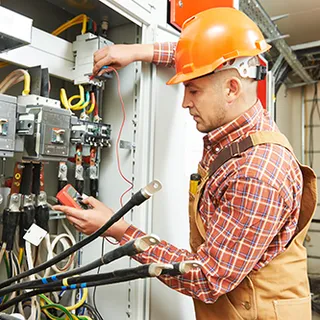 Electrician working on an electrical panel