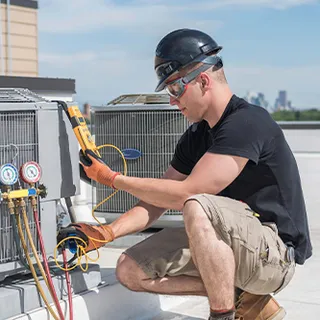 HVAC technician servicing a unit