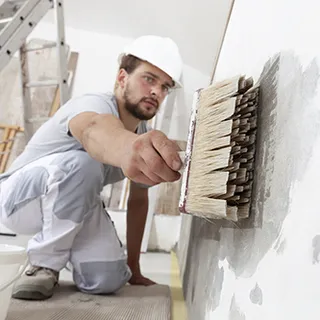 Painter painting an interior wall