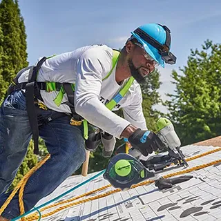 Roofer installing shingles